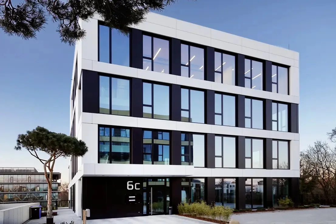 The Medical Balance Group clinic building at Konrad-Zuse-Ring 6c, Campus Jungfernsee, Potsdam — a modern white and glass façade with pine trees
