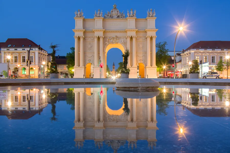 Brandenburg Gate in Potsdam reflected in water at blue hour